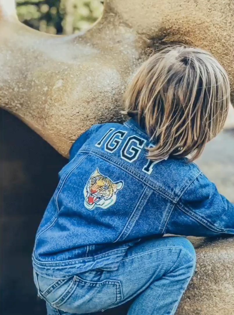Iggy wearing a personalised denim jacket with a tiger patch